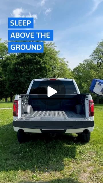 the back end of a pickup truck parked in a field