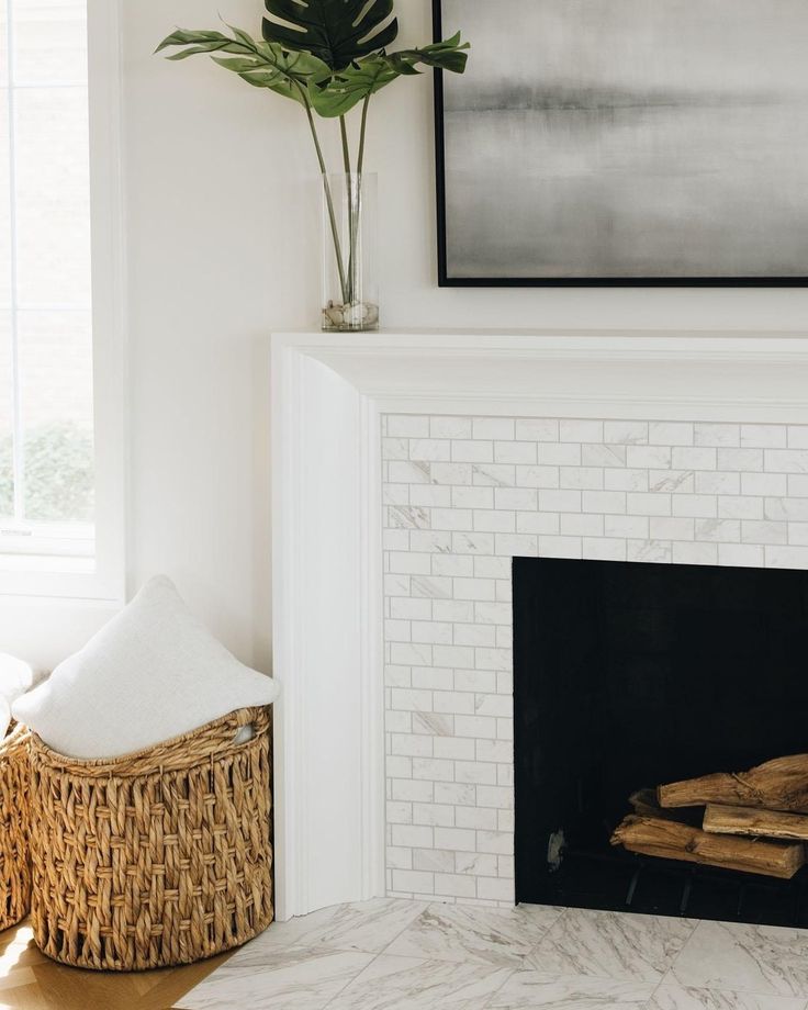 a living room with a white brick fireplace and potted plant next to it on the mantle