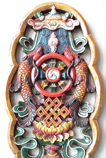 an intricately decorated wall hanging on the side of a white wall with red and green decorations