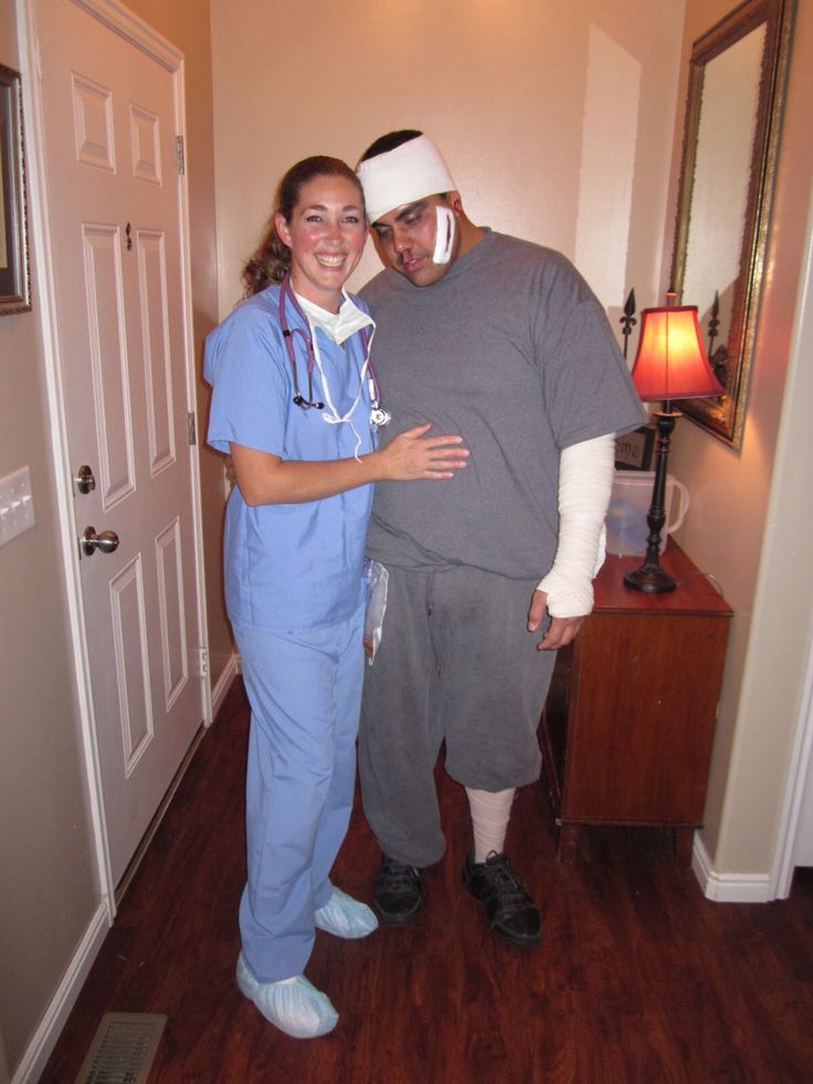 a man and woman in scrubs standing next to each other on a wooden floor