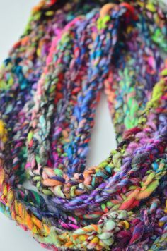 a multicolored knitted scarf on a white surface