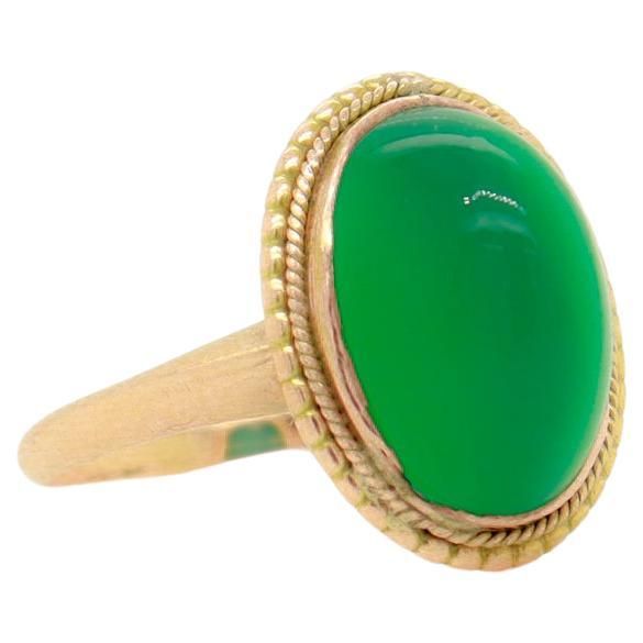 A fine antique Edwardian cabochon ring. In 14 karat yellow gold. Bezel-set with an oval chrysoprase sugarloaf cabochon in a beaded & twisted wire setting. Marked 14k to the shank. Simply a wonderful vintage ring! Date: Late 19th or Early 20th Century Overall Condition: It is in overall good, as-pictured, used estate condition. Condition Details: There is a small spot of loss and some light bending & indentations to the bezel setting. Otherwise, there are some fine & light surface scratches and o Luxury Cabochon Domed Ring, Victorian Oval Yellow Gold Emerald Ring, Victorian Oval Emerald Ring In Yellow Gold, Heirloom Yellow Gold Emerald Cabochon Ring, Antique Gold Emerald Cabochon Ring, Antique Emerald Ring Oval Cabochon, Antique Emerald Ring With Oval Cabochon, Heirloom 14k Gold Cabochon Emerald Ring, 14k Yellow Gold Emerald Ring Oval Cabochon