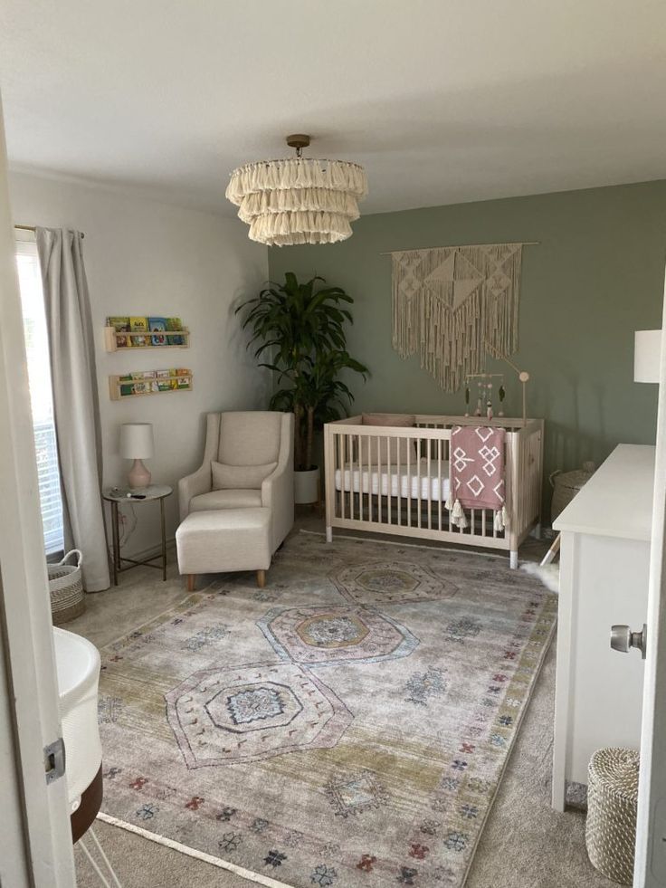 a baby's room with a crib, chair, rug and potted plant