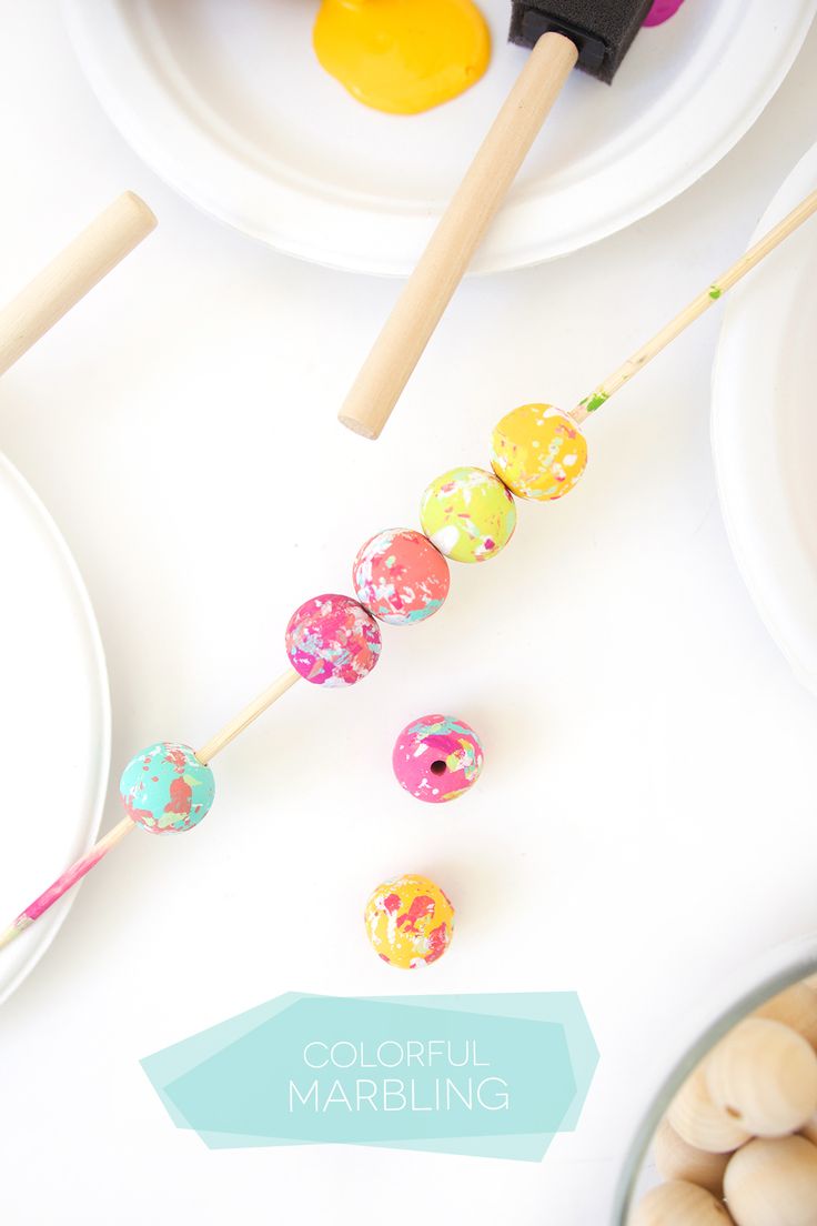 colorful marblings are on the table next to bowls and utensils