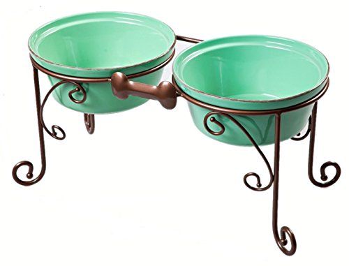 two green bowls sitting on top of metal stand