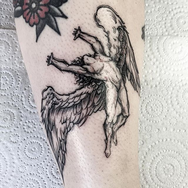 an artistic tattoo on the leg of a woman with angel wings and star above her head