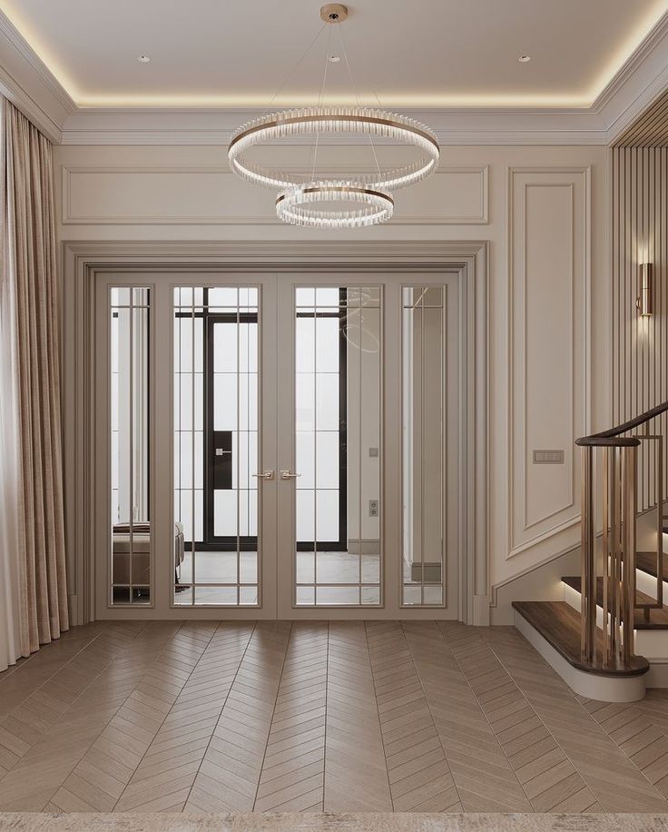 an empty room with stairs and chandelier in the center, surrounded by beige curtains