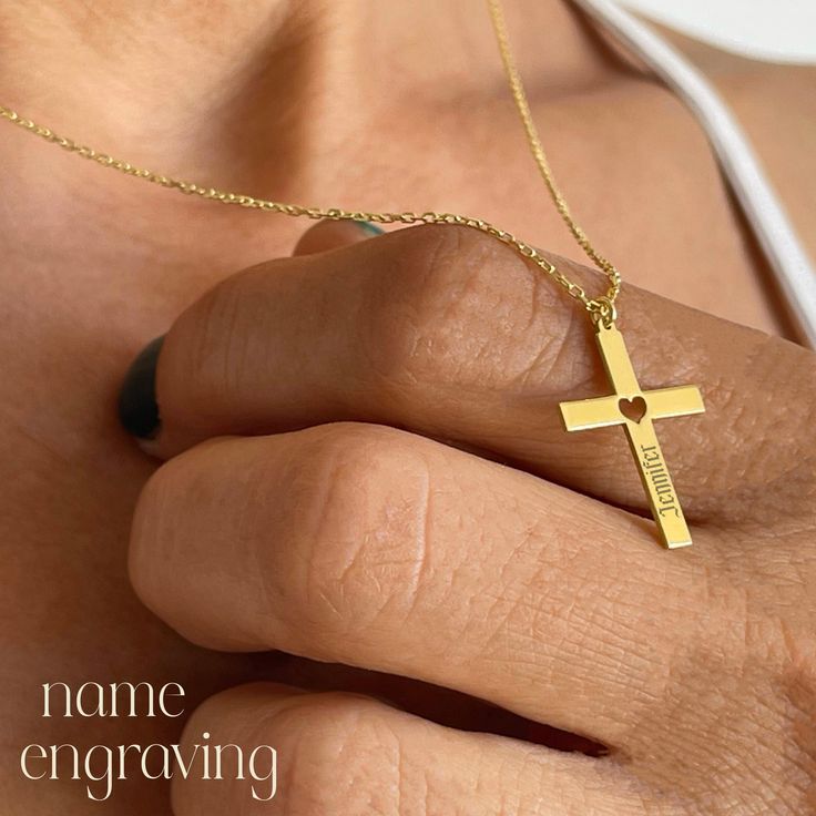 Discover the beauty of our 14k Solid Gold Cross Pendant with a Heart Cut-Out, an exquisite choice for baptisms, communions, and confirmations. Crafted from pure 14k gold, this stunning pendant combines elegance with lasting quality. The heart-shaped cut-out adds a unique, personal touch, making it an ideal gift for her. Each piece arrives in a stylish gift box and is stamped with -585- to ensure its 14k gold authenticity. Enhance this special gift with custom laser engraving to create a memorabl 14k Gold Cross Jewelry For Anniversary, Yellow Gold Cross Wedding Jewelry And Charms, Personalized Yellow Gold Necklaces For First Communion, Personalized Gold Crucifix Jewelry, Personalized Cross Pendant Jewelry For Mother's Day, Personalized Yellow Gold Necklace For First Communion, Personalized Rose Gold Cross Jewelry, Gold Cross Jewelry For Valentine's Day, 14k Gold Crucifix Jewelry For Anniversary