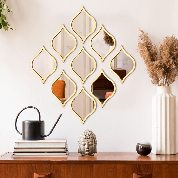 a wall mounted mirror on the side of a wooden dresser next to a potted plant