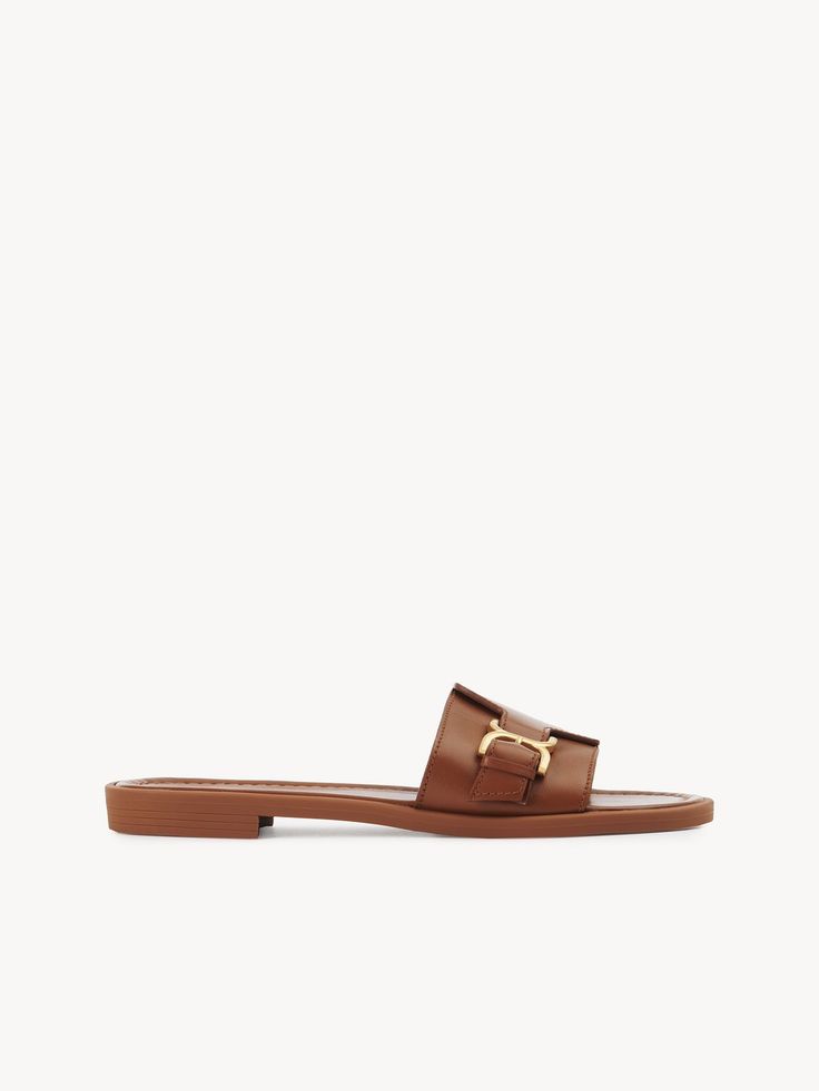 Chloé Marcie Slide | Chloé US Elegant Leather Mules With Rectangular Buckle, Luxury Calf Leather Slides With Buckle Closure, Elegant Leather Slides With Buckle Closure, Classic Sandals With Tang Buckle In Calf Leather, Classic Leather Sandals With Rectangular Buckle, Chic Formal Calf Leather Slides, Designer Leather Sandals With Gold Buckle, Elegant Calf Leather Slides For Spring, Luxury Calf Leather Slides With Leather Footbed