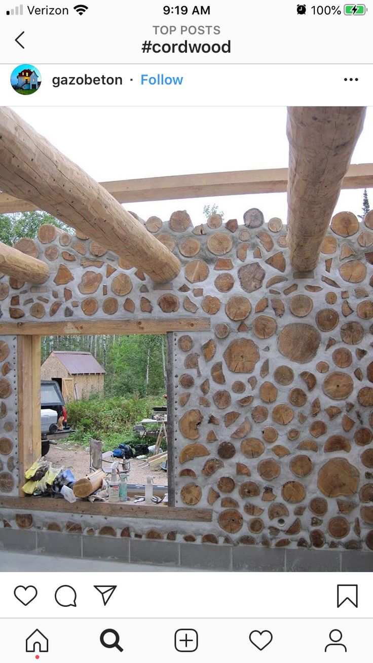 an unfinished room with stone walls and wood beams