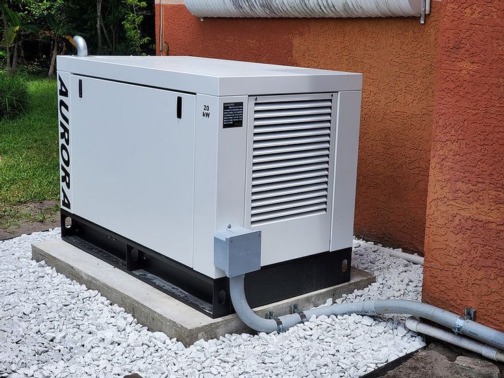 an air conditioner sitting on top of gravel next to a building with a hose connected to it