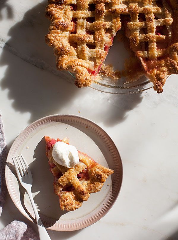 a slice of pie on a plate next to another piece of pie with a scoop of ice cream