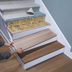 a child is sitting on the floor with some stairs