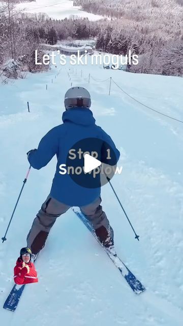 a man riding skis down a snow covered slope next to a child on skis