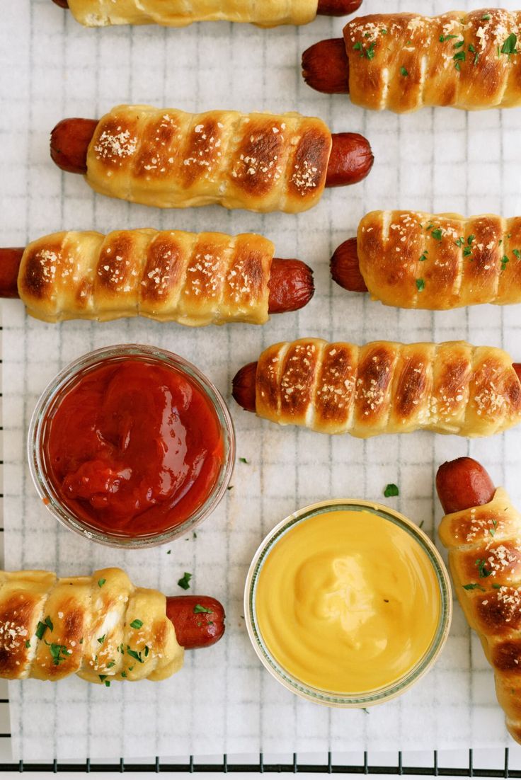 hotdogs and condiments lined up on a cooling rack