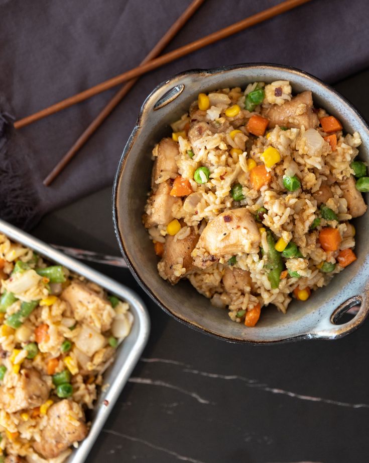 two pans filled with food sitting on top of a table