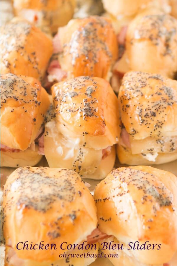 there are many rolls covered in cheese and black sprinkles