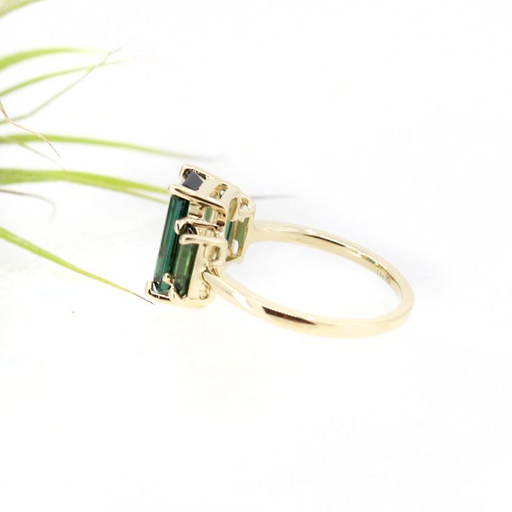 The showstopper. Three lush luxurious AA green tourmalines are set in slim claw settings and sit atop a classic round band. Classic with a twist, this art deco inspired piece makes a fantastic statement ring or a wedding piece. Metaphysically, green tourmaline carries the essence of the earth and her plant kingdom. It's conducive to healing, happiness, and setting a clear & grounded direction for the future. 3.79 ctw AA green tourmaline and solid 14k yellow gold. US size 7 but can be resized Classic Green Tourmaline Jewelry, Elegant Emerald Cut Tourmaline Jewelry, Elegant Emerald Cut Tourmaline Ring, Elegant Emerald-cut Tourmaline Ring, Timeless Green Rings With Accent Stones, Baguette Cut Tourmaline Jewelry For Weddings, Elegant Tourmaline Rings With Accent Stones, Elegant Tourmaline Sapphire Ring For Wedding, Elegant Tourmaline Sapphire Wedding Ring