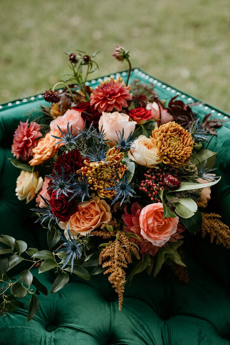 a bouquet of flowers sitting on top of a green chair