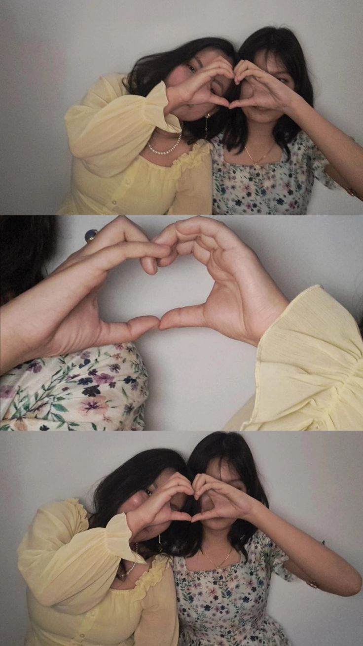 two women making heart shapes with their hands