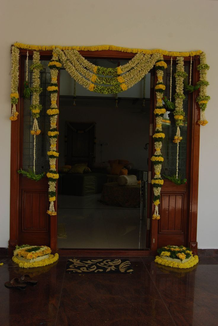 an entrance decorated with flowers and garlands