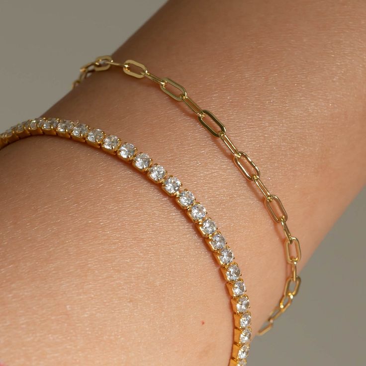 Our Paperclip bracelet is a golden staple to wear alone or stack with our other gold filled bracelets. Our 14k gold-filled jewelry is bonded with 14k gold and is water and tarnish resistant. 14k gold-filled jewelry is a great alternative to solid gold, and can be worn by people with sensitive skin. The color will not tarnish but recommend to keep away from perfumes and lotions. - 14k gold-filled- Chain width: 3.5 mm.- Chain length: 6"- Water resistant / Tarnish resistant / Hypoallergenic Minimalist Gold Tennis Bracelet For Everyday, Everyday Gold Tarnish Resistant Tennis Bracelet, Everyday Gold Tarnish-resistant Tennis Bracelet, Dainty Gold Paperclip Bangle Bracelet, Dainty 14k Gold Tennis Bracelet For Everyday Wear, 14k Gold-filled Yellow Gold Paperclip Bracelet, Tarnish Resistant, 14k Gold Filled Tarnish-resistant Paperclip Bracelet As Gift, 14k Gold-filled Tarnish Resistant Paperclip Bracelet As Gift, 14k Gold Filled Tarnish Resistant Paperclip Bracelet Gift