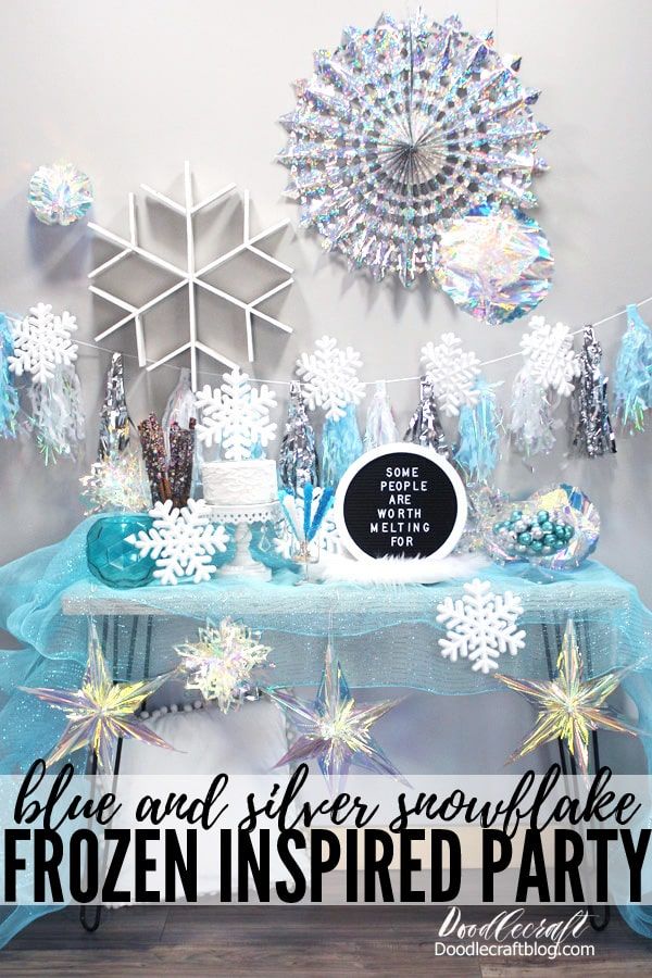 the table is decorated with snowflakes, stars and decorations for a winter wonderland party