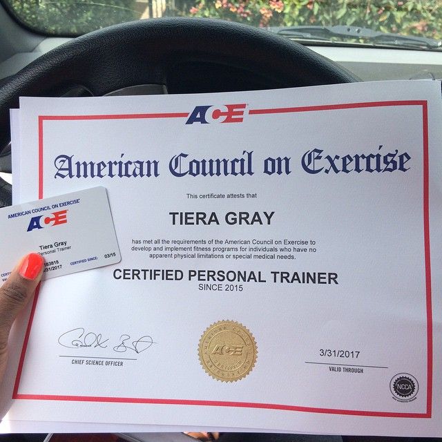 a person holding up a certificate in their car