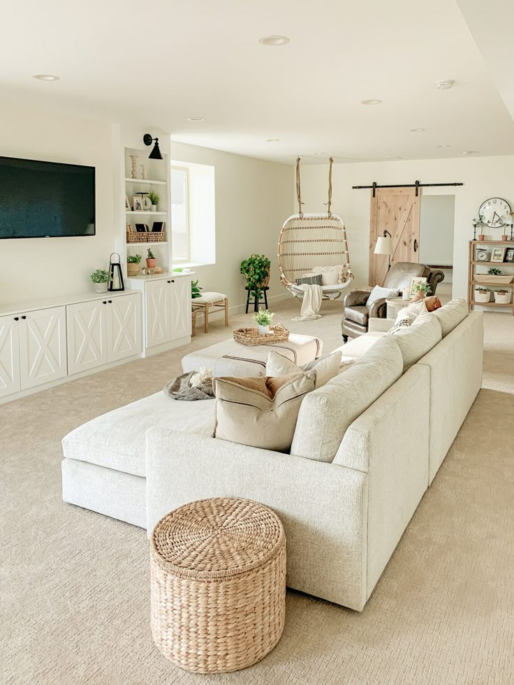 a living room filled with furniture and a large flat screen tv mounted to the wall