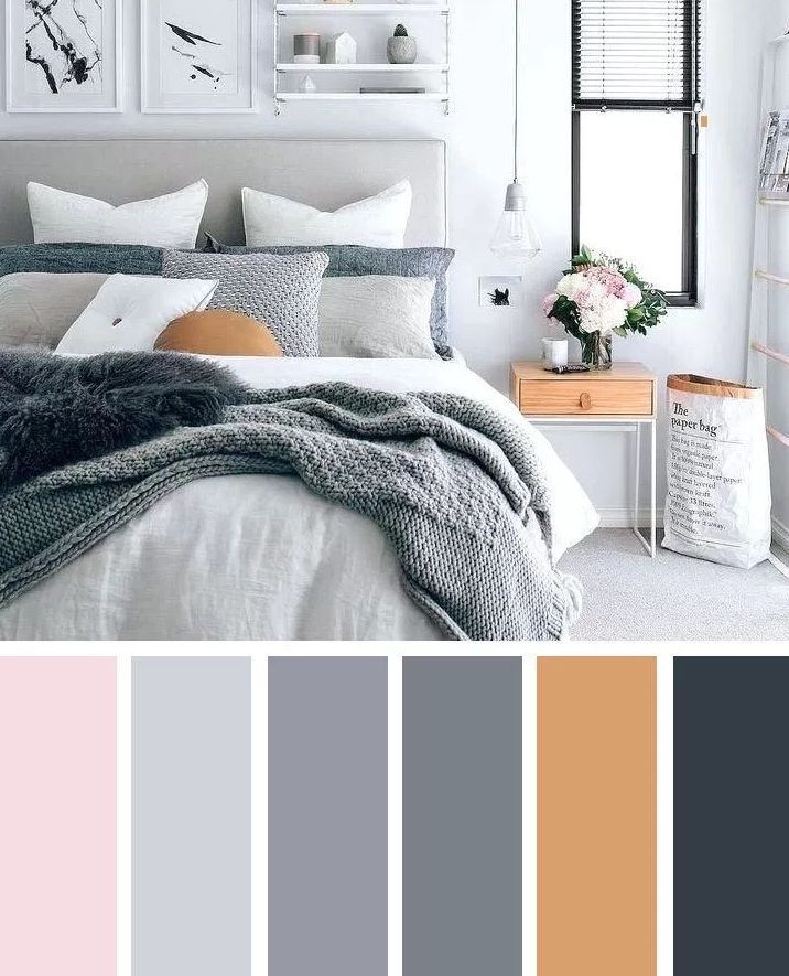 a bedroom with white walls, grey bedding and neutrals in the color scheme