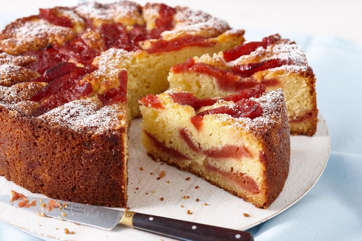 a cake that has been cut into pieces and is on a plate with a knife