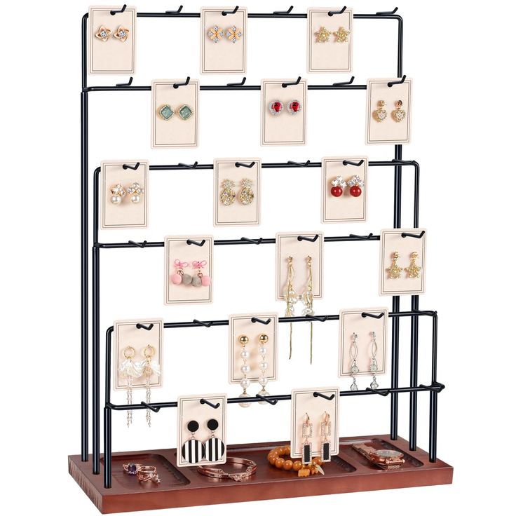 a display case with earring holders and pictures hanging on it's sides in front of a white background