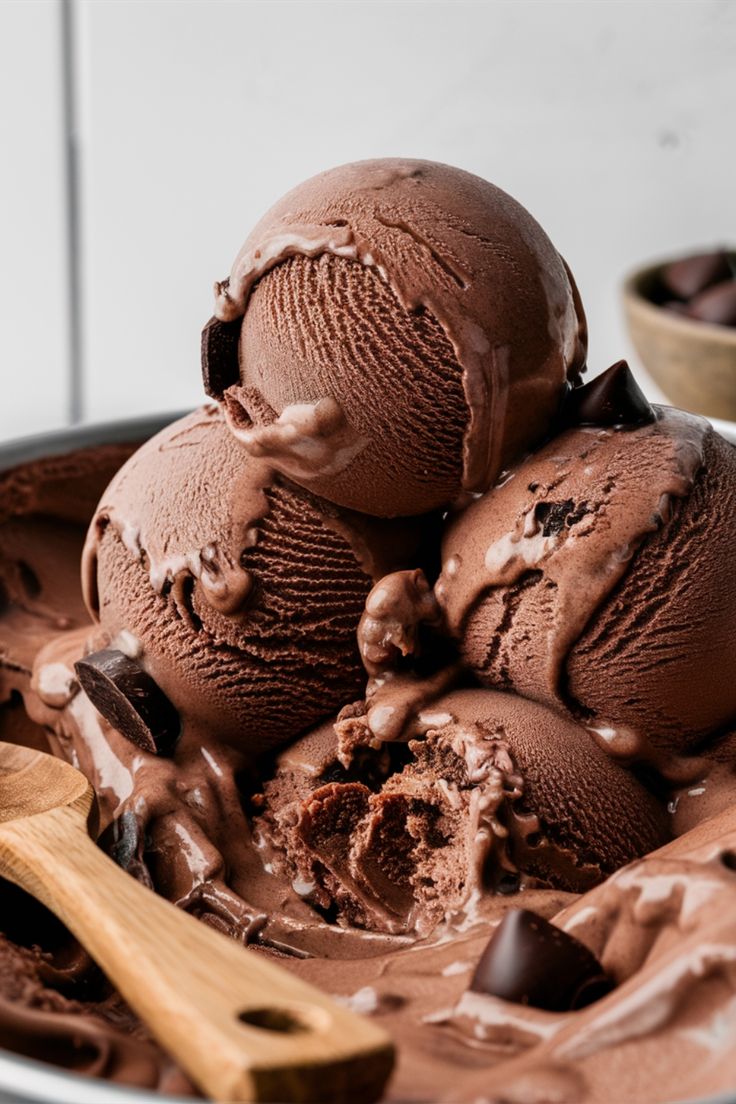 three scoops of chocolate ice cream in a bowl