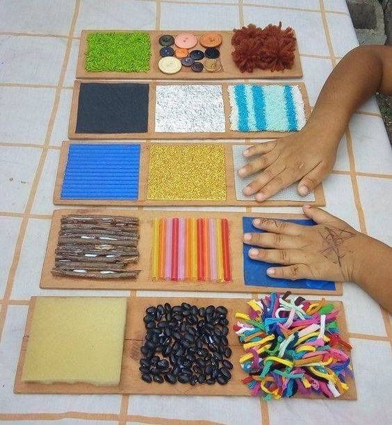 the child is playing with different materials on the table