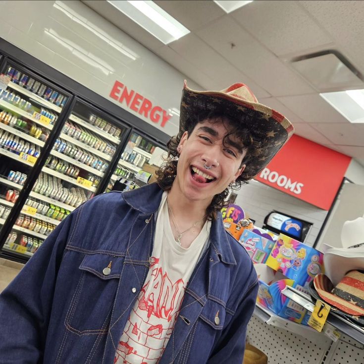 a young man wearing a funny hat in a grocery store