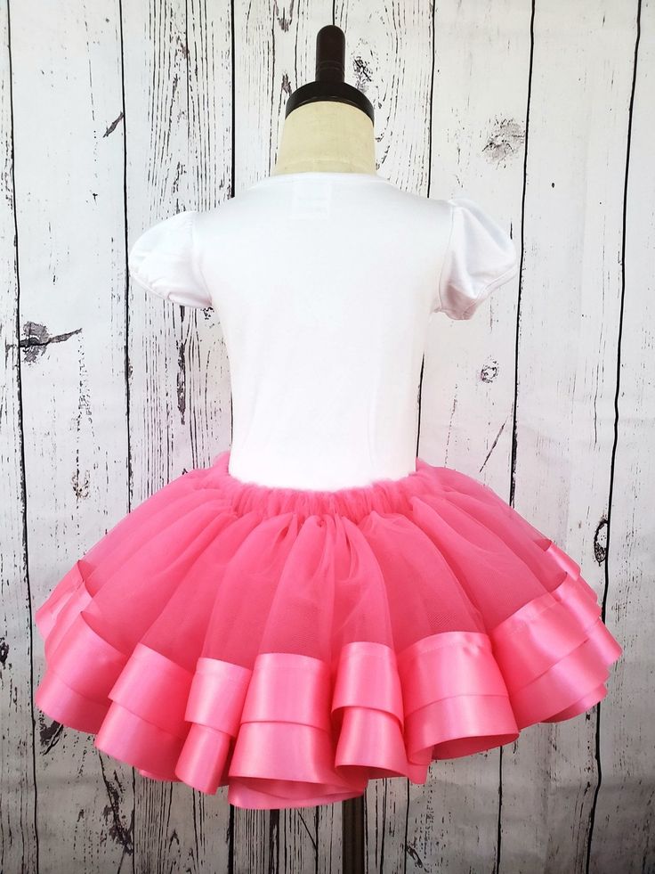 Pink Tulle Tutu Skirt Make her twirl with delight in our Pink Tulle Tutu Skirt. Our premium tulle is soft against the skin and won't snag, scratch, or irritate. Double-faced satin ribbon adds a sweet, elegant touch, while our sizing chart ensures a perfect fit. Spark her imagination and unleash her inner princess. Lead time to sew and ship is 3 business days Tutu Skirts, Tulle Tutu Skirt, Tulle Tutu, Pink Tulle, Tutu Skirt, Bubblegum Pink, Pink Ribbon, Lead Time, Sizing Chart