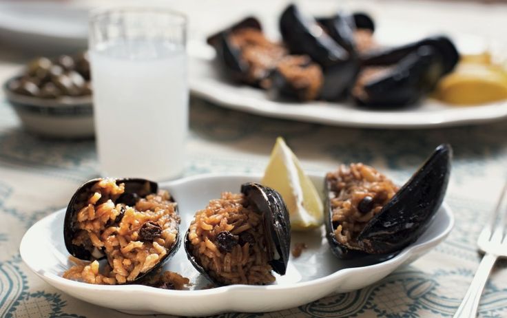 a plate with mussels and rice on it