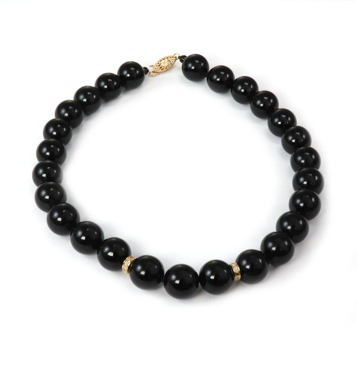 "Hallmark: 14k Material: 14k yellow gold Diamond: 15 points Gemstone: onyx beads (13.5mm - 13.8mm) Measurements: 15.5\" long x 13.8mm Weight: 94.9 grams This is an elegant beaded necklace. It features a single strand with high polished onyx beads 3.5-3.8mm in size. The center of the necklace has two 14k yellow gold ring between the beads and it has round cut sparkling diamonds. The yellow gold clasp is a long floral filigree design with a hook and push in closure. It has the 14k metal content st Classic Onyx Jewelry With Gemstone Beads, Formal Black Jewelry With Gemstone Beads, Formal Black Gemstone Beads Jewelry, Formal Onyx Jewelry With Gemstone Beads, Formal Onyx Gemstone Beads Jewelry, Formal Onyx Beaded Necklaces With Polished Beads, Formal Onyx Round Bead Necklaces, Formal Onyx Beaded Necklace With Polished Beads, Formal Onyx Beaded Necklace With Round Beads