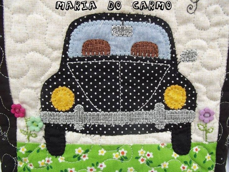 a black and white car with yellow flowers on it's side is featured in this quilted applique