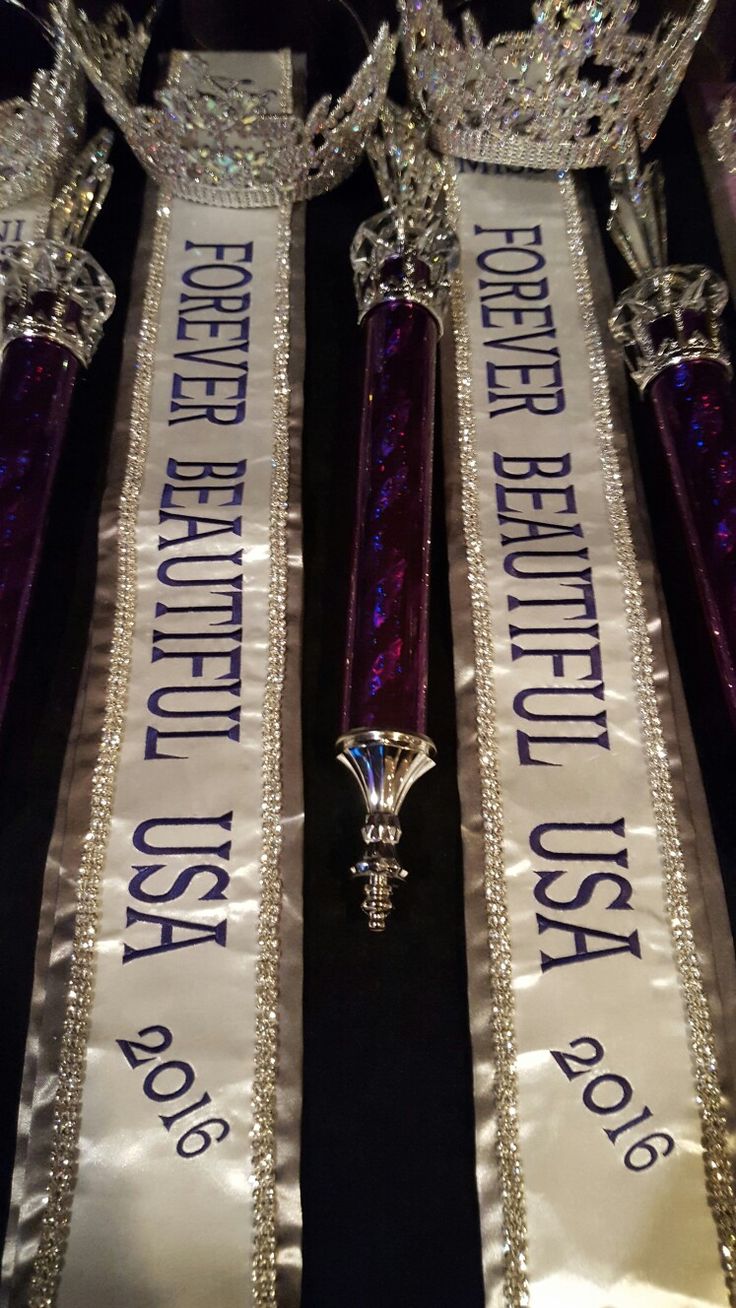 two purple and silver sashes with tiaras on them