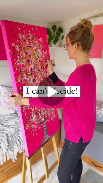 a woman is painting on an easel in her bedroom with the words i can't decide