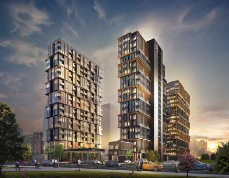 two tall buildings next to each other on a city street at sunset or dawn with cars parked in the foreground