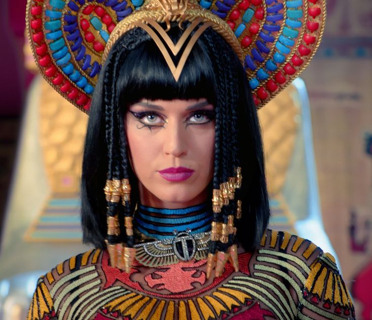 an egyptian woman with black hair and headdress