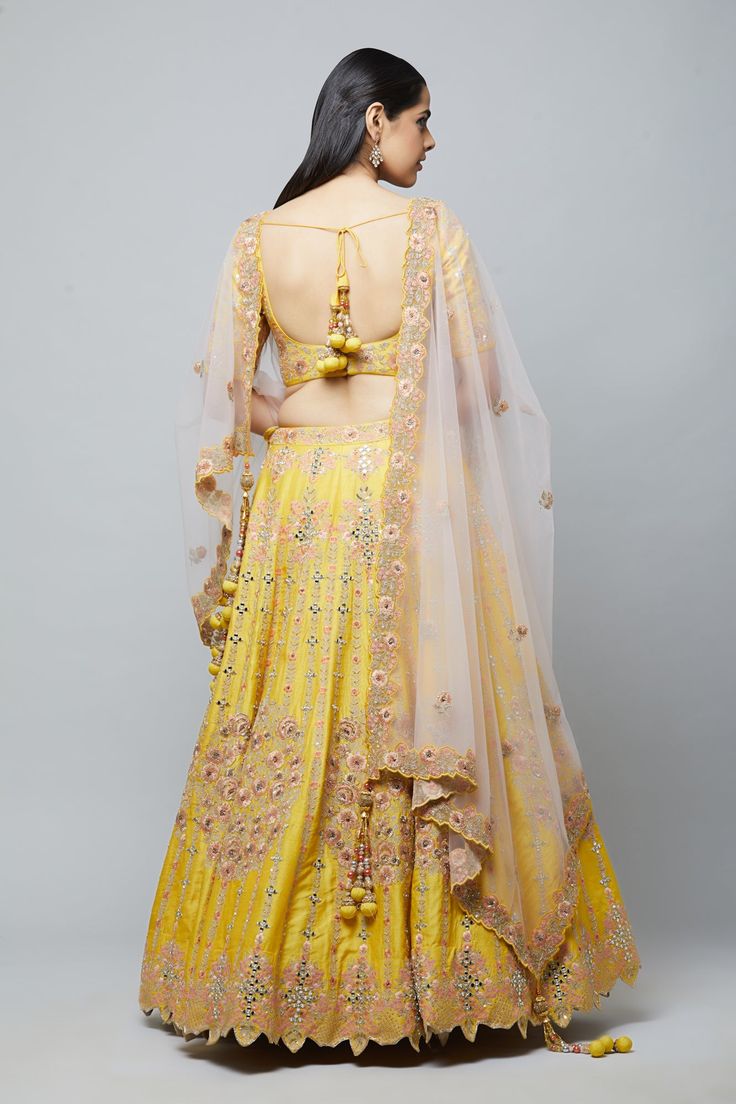 Beautifully embroidered with gold aari and peach resham embroidery, this lehenga will brighten up any wedding event! Fabric: Raw silk blouse and lehenga, Net dupatta All preorders will be handled by a Nazranaa Bridal Consultant who will virtually discuss measurements and minor changes according to the client's specifications Occasion: Wedding Events such as sangeet or wedding ceremony WASH CARE INSTRUCTIONS - Please Dry clean only when it is applicable. Slight color variation is possible due to Raw Silk Blouse, Resham Embroidery, Bridal Consultant, Net Dupatta, Raw Silk, Wedding Event, Silk Blouse, Lehenga, Wedding Events