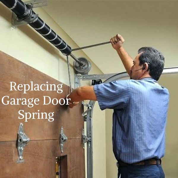 a man is repairing the garage door spring