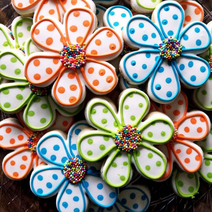 decorated cookies in the shape of flowers on a plate