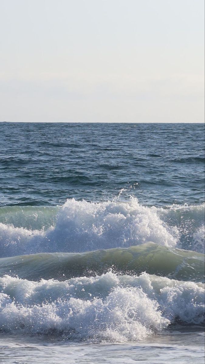 two surfers are riding the waves in the ocean