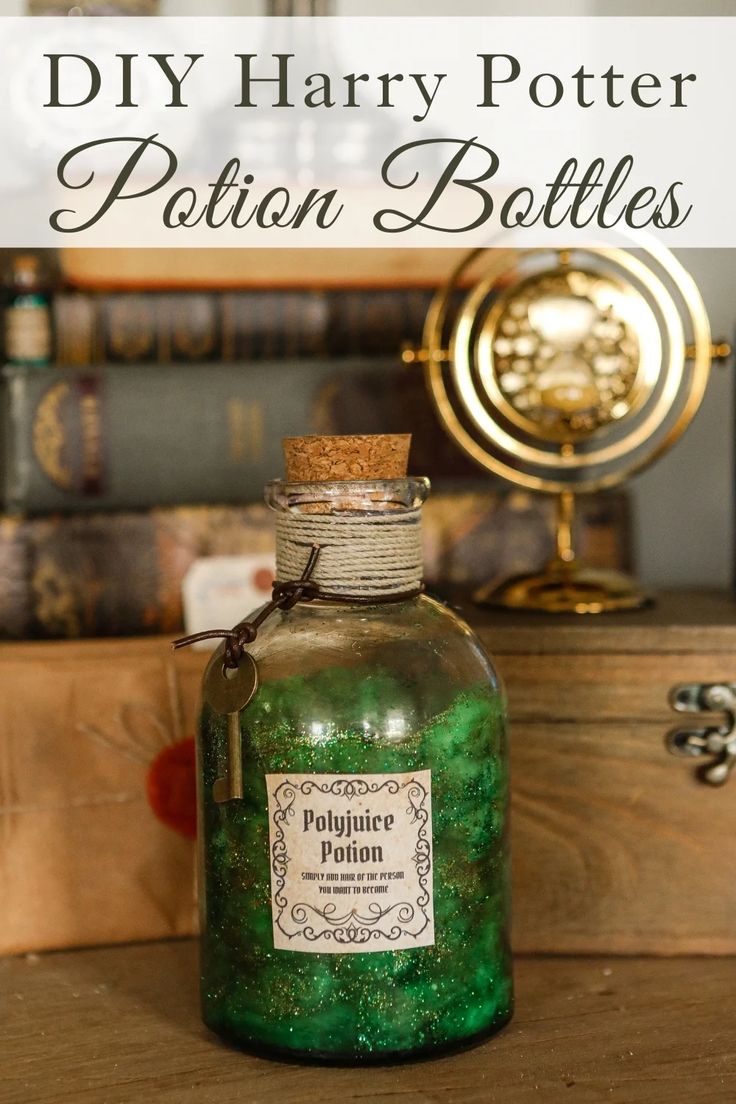 a bottle filled with green liquid sitting on top of a wooden table next to books