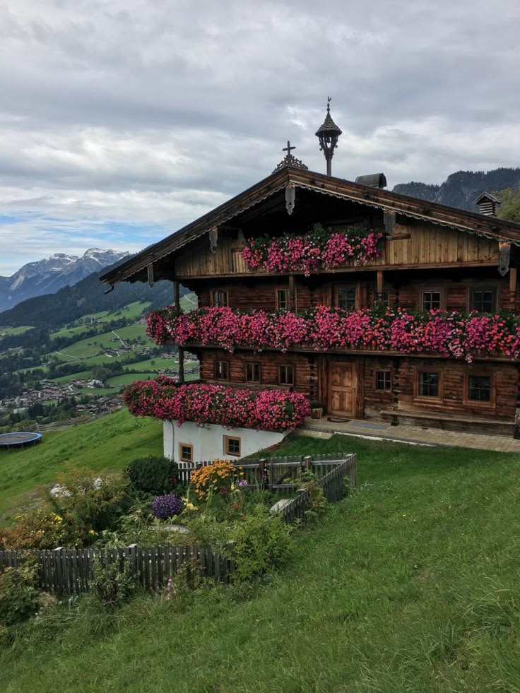 a house with flowers growing on the side of it